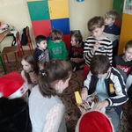 Dzieci otwierają worek z prezentami.