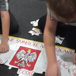 Dzieci układaja z puzzli godło Polski.jpg